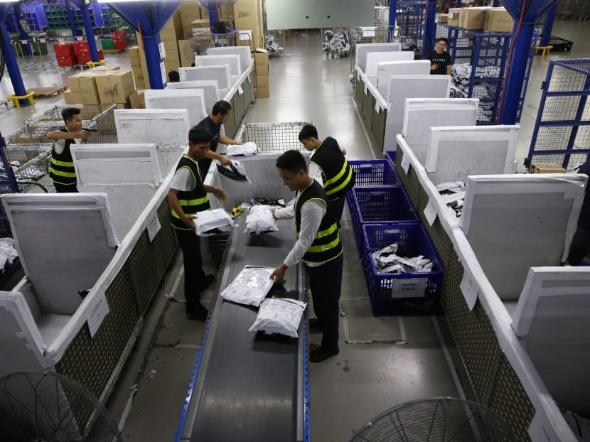 Zalora employees sorting customers' packages according to the delivery location at its warehouse in Selangor, Malaysia.