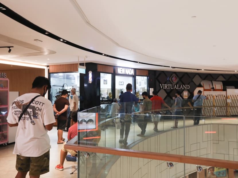 A long queue of customers at the New Nada barbershop at Century Square mall in Tampines around 11am on May 12, 2020.