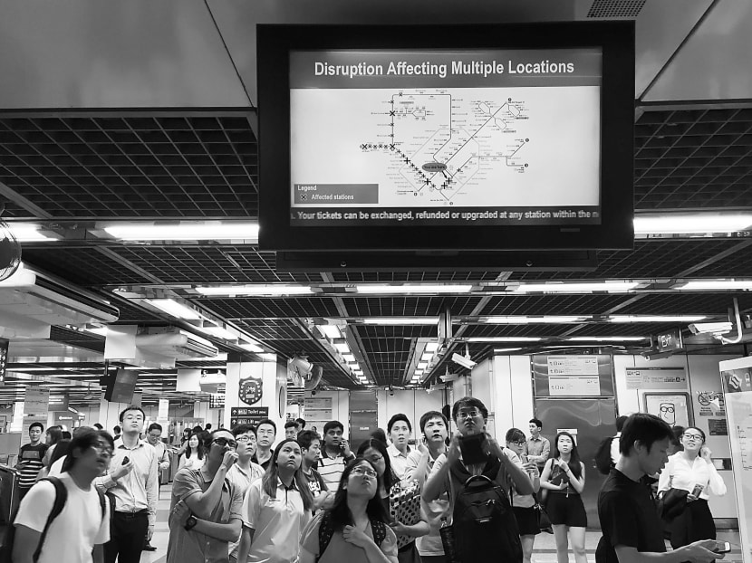 Commuters at City Hall MRT Station being notified about a disruption. TODAY file photo