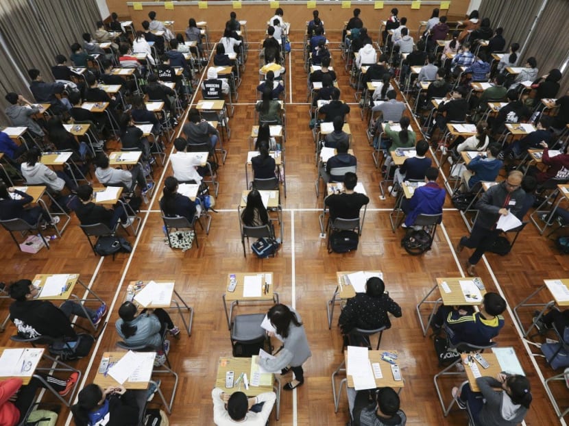 Students taking the Hong Kong Diploma of Secondary Education examination at Kowloon Technical School.