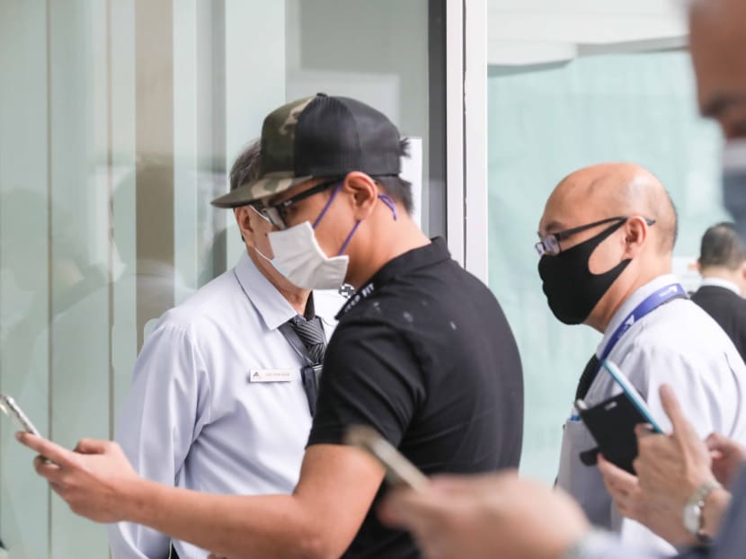 Mohamed Sharizad Mohamed Samsuri (centre) posed as women on Facebook to harass his victim and threatened to post nude videos of her online if she did not meet him.