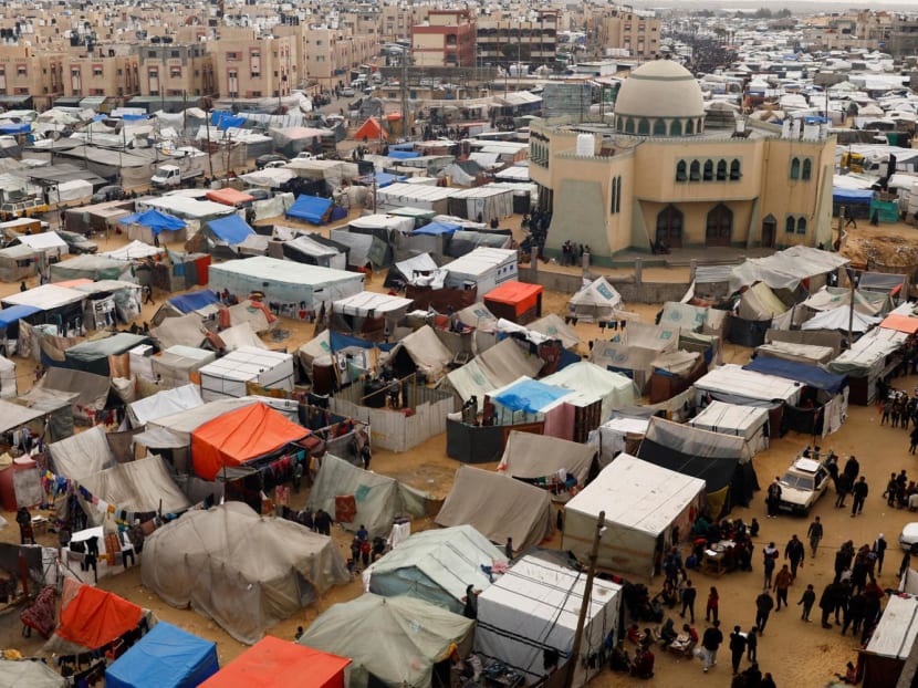 Displaced Palestinians, who fled their houses due to Israeli strikes, shelter at a tent camp, amid the ongoing conflict between Israel and Hamas, in Rafah in the southern Gaza Strip on Feb 27, 2024. 