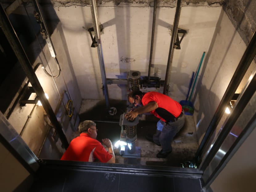 BCA engineers checking the buffers in the lift pit at Blk 273D Compassvale Link on Jul 8, 2016. TODAY file photo