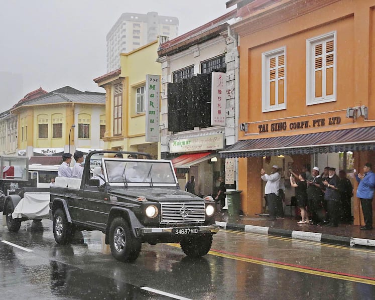 Crowds brave torrential downpour as Othman Wok is laid to rest