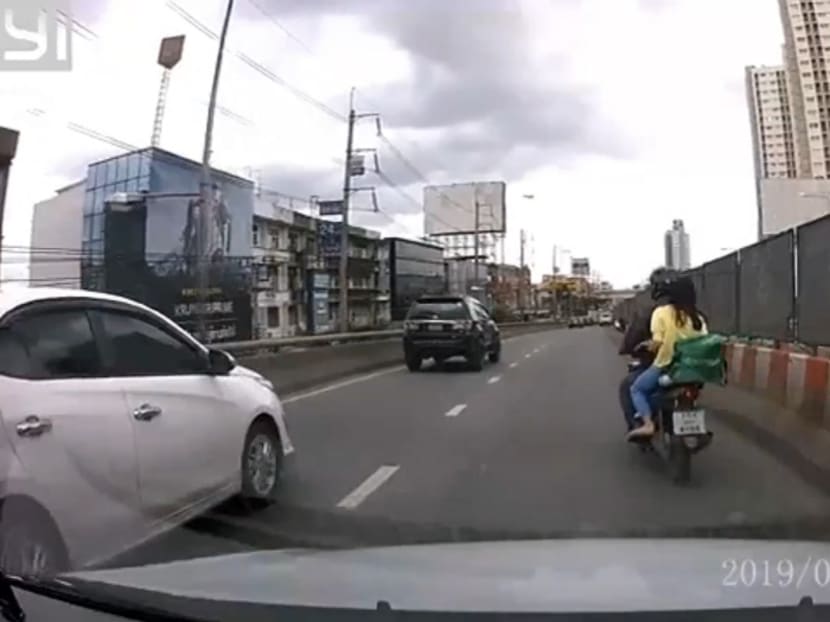 A Grab food delivery driver takes a mother and her seriously ill son to a hospital on Monday.