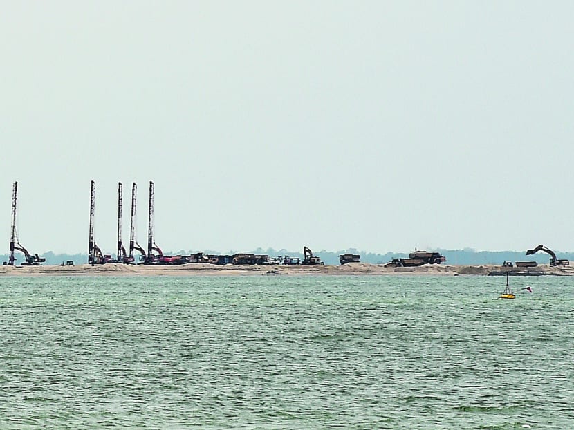 Reclamation work off the Strait of Johor for Malaysia’s Forest City project. The proposed changes in the preliminary report include replanting seagrass and building two parallel water channels across the reclaimed island. TODAY FILE PHOTO