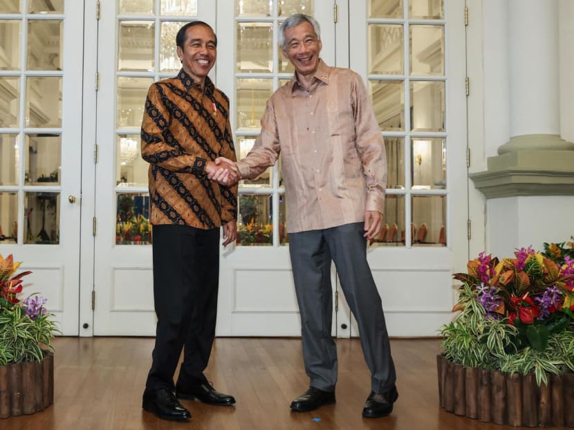 Singapore's Prime Minister Lee Hsien Loong (right) shaking hands with Indonesia's President Joko Widodo (left) as they meet at the Istana in Singapore on March 16, 2023. Singapore's Prime Minister Lee Hsien Loong (right) shaking hands with Indonesia's President Joko Widodo (left) as they meet at the Istana in Singapore on March 16, 2023.