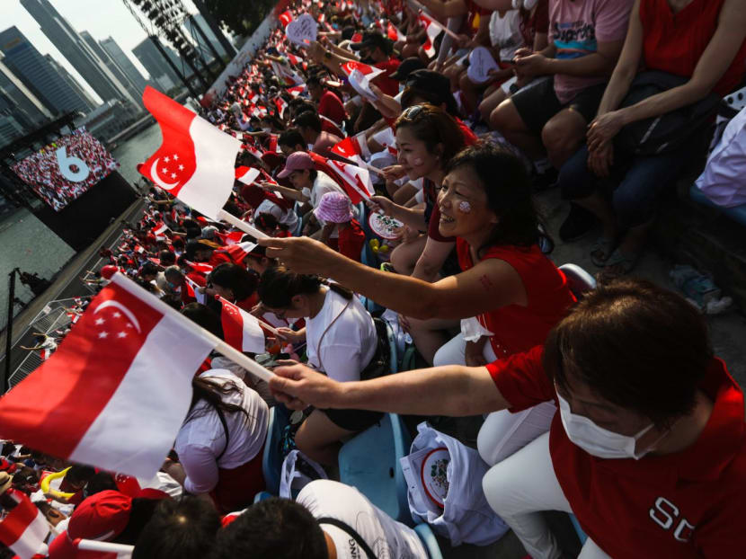 People waving the Singapore flag at the 2022 National Day Parade. People waving the Singapore flag at the 2022 National Day Parade.