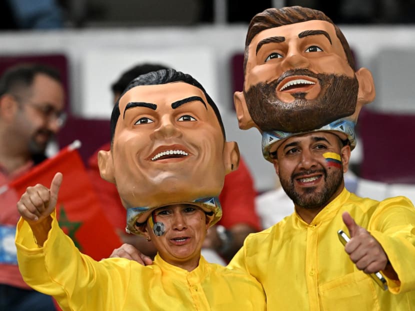 Football fans wearing masks of Portugal forward Cristiano Ronaldo and Argentina forward Lionel Messi pose prior to the Qatar 2022 World Cup third place play-off football match between Croatia and Morocco at Khalifa International Stadium in Doha on Dec 17, 2022.
