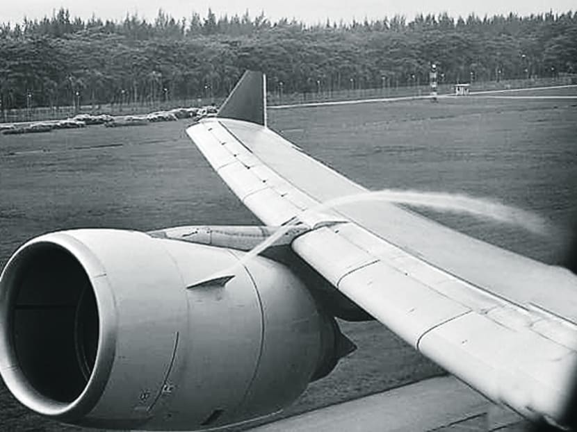 When taking off and landing at Changi Airport, the writer saw this stream of white stuff flowing from the engine and over the wing, and wanted to know what caused it. Photo: C Frank Starmer
