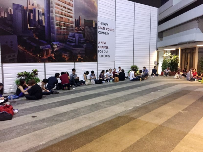 A queue formed outside the State Courts early yesterday. At 6am, close to 100 people were in the queue and queue numbers were given to the first 55 an hour later, according to CNA. Photo: Channel NewsAsia