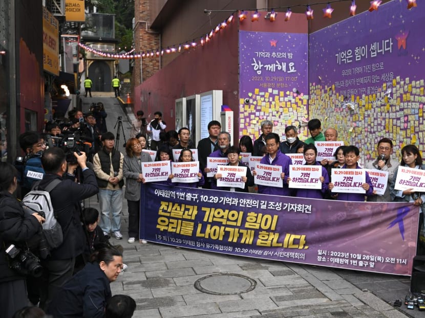 Families of Itaewon crush victims hold signs reading "I will remember the 10.29 Itaewon disaster!" during an unveiling ceremony of a memorial street marker to remember the victims of the October 26, 2022 crowd crush that killed more than 150 people during Halloween celebrations, at the site of the tragedy in the popular Itaewon nightlife area in Seoul on October 26, 2023. The narrow alleyway in South Korea's capital where nearly 160 people were crushed to death during Halloween festivities a year ago was designated a "Memorial Alley" on October 26, victims' relatives said. Families of Itaewon crush victims hold signs reading "I will remember the 10.29 Itaewon disaster!" during an unveiling ceremony of a memorial street marker to remember the victims of the October 26, 2022 crowd crush that killed more than 150 people during Halloween celebrations, at the site of the tragedy in the popular Itaewon nightlife area in Seoul on October 26, 2023. The narrow alleyway in South Korea's capital where nearly 160 people were crushed to death during Halloween festivities a year ago was designated a "Memorial Alley" on October 26, victims' relatives said.