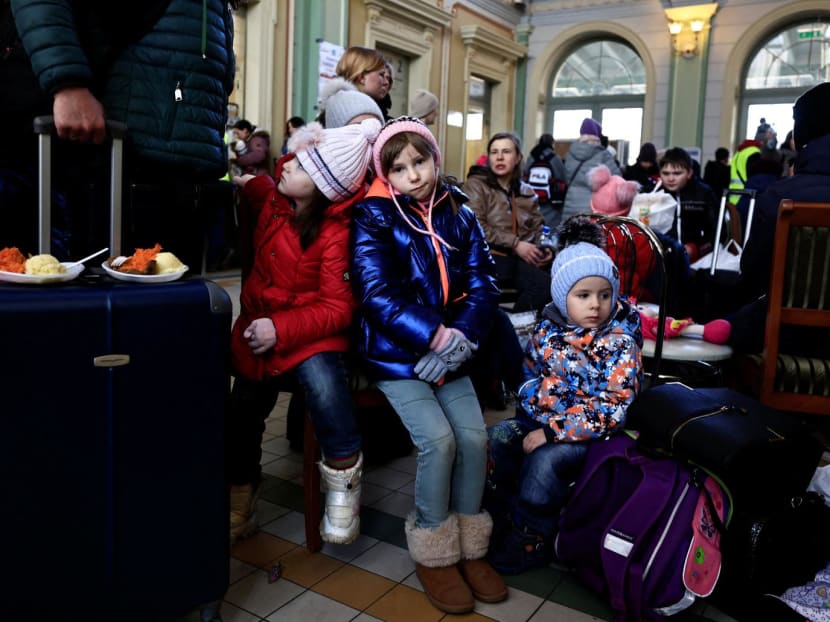 Girls rest at a train station, after fleeing Russia's invasion of Ukraine, in Przemysl, Poland, March 17, 2022.