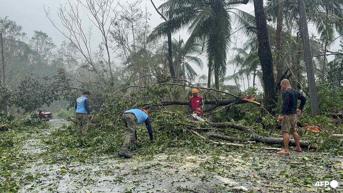 Floods strand people on roofs as typhoon pounds Philippines
