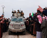 Syrian troops sweep northern towns as Kurdish fighters withdraw