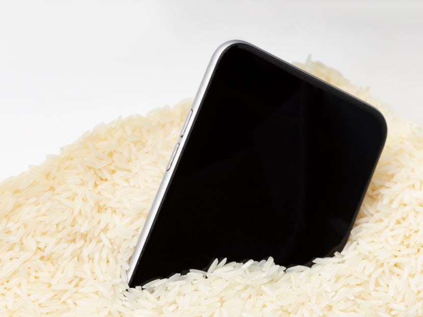A mobile phone placed in rice, a common method used to dry wet phones.