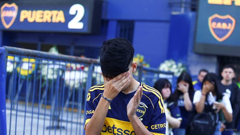 Players and fans join family members at Russo's funeral at Boca stadium