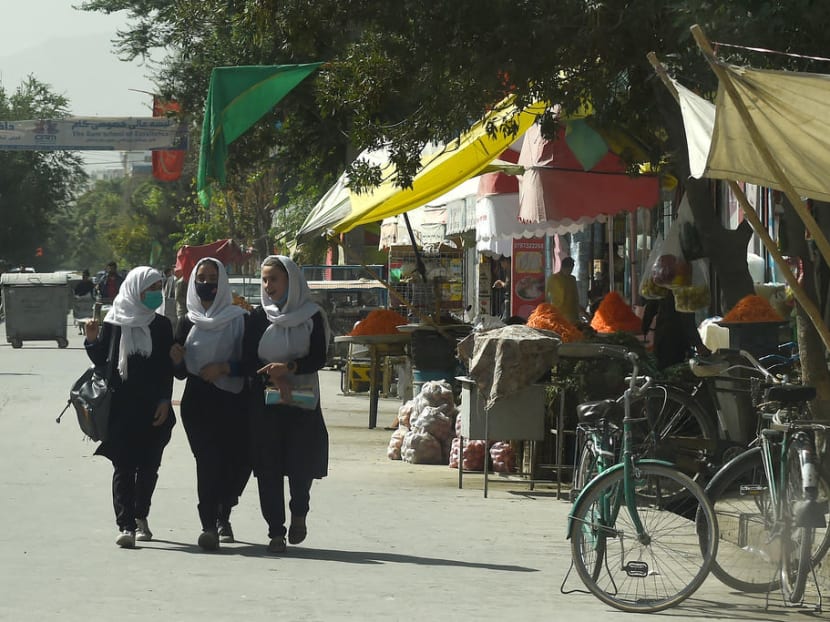 Afghan school girls walking through a street in Kabul on Aug 15, 2021.