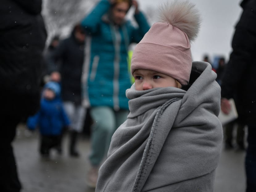 A child is wrapped in a blanket as Ukrainian refugees cross the border into Poland on March 9, 2022. A child is wrapped in a blanket as Ukrainian refugees cross the border into Poland on March 9, 2022.