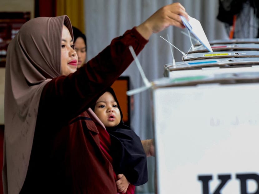 A woman votes at a polling station during the general election in Bogor, West Java, Indonesia, on Feb 14, 2024. A woman votes at a polling station during the general election in Bogor, West Java, Indonesia, on Feb 14, 2024.