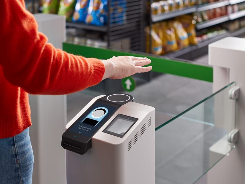A person waves their hand above the new Amazon palm recognition payment system called "Amazon One" in Seattle, Washington. A person waves their hand above the new Amazon palm recognition payment system called "Amazon One" in Seattle, Washington.