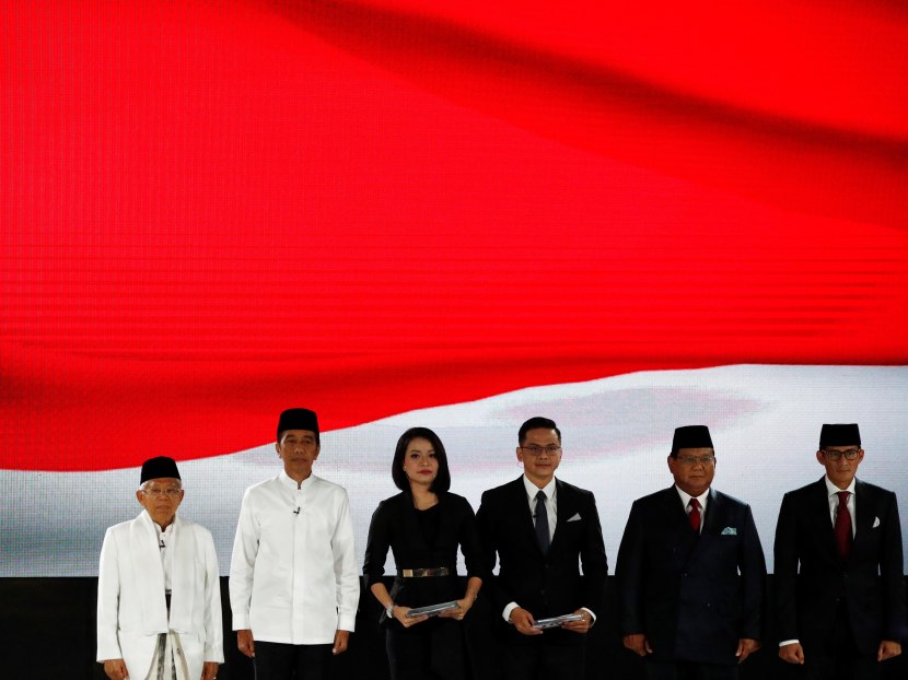 Indonesia's President Joko Widodo, his running mate Ma'ruf Amin, presidential candidate Prabowo Subianto and his running mate Sandiago Uno sing the national anthem before their last presidential debate in Jakarta, Indonesia April 13, 2019. Indonesia's President Joko Widodo, his running mate Ma'ruf Amin, presidential candidate Prabowo Subianto and his running mate Sandiago Uno sing the national anthem before their last presidential debate in Jakarta, Indonesia April 13, 2019.