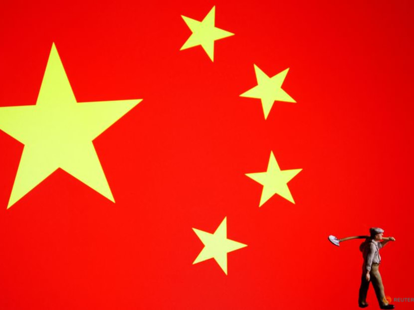 FILE PHOTO: A worker miniature is displayed with the flag of China in this illustration picture taken on July 6, 2023. REUTERS/Florence Lo/Illustration/File Photo