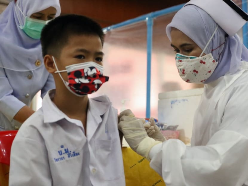 A medical worker administers a dose of the Pfizer vaccine against the Covid-19 coronavirus to a school student at a vaccination centre in southern Thailand's Pattani province on Oct 7, 2021.