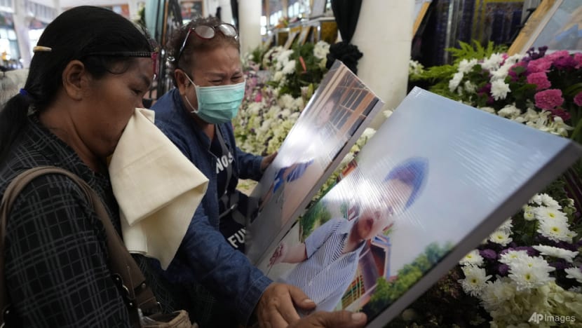 Grieving families pray at Thai temple for slain nursery victims