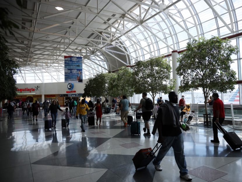 Passengers walk between terminals at Charlotte Douglas International Airport on May 15, 2020 in Charlotte, North Carolina. Passengers walk between terminals at Charlotte Douglas International Airport on May 15, 2020 in Charlotte, North Carolina.