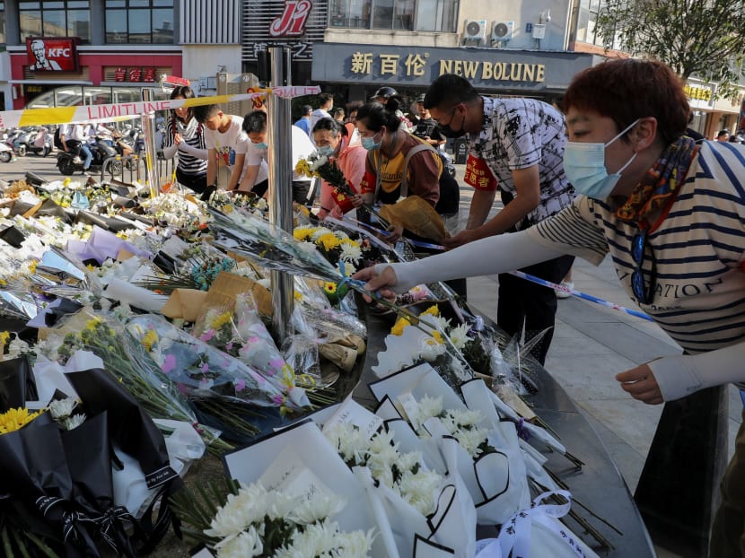Volunteers arrange flowers at the site of a stabbing which left 6 people dead and 14 wounded, in Anqing, in China's eastern Anhui province on June 6, 2021. Volunteers arrange flowers at the site of a stabbing which left 6 people dead and 14 wounded, in Anqing, in China's eastern Anhui province on June 6, 2021.