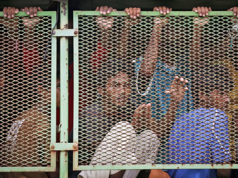 Migrants are seen on truck as they being transfer to a Navy base in Langkawi Island, Malaysia, on Wednesday, May 13, 2015. Photo: AP