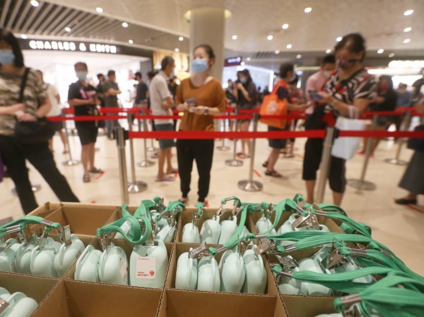 People collecting their TraceTogether tokens in Bedok Mall on Oct 4, 2020.