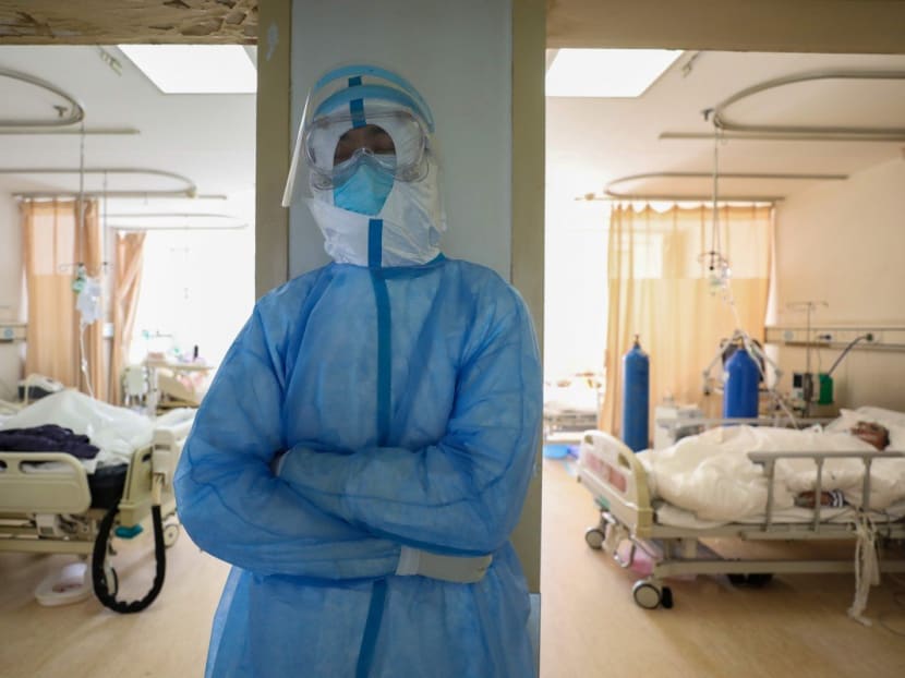 A medical worker in protective suit takes a break at an isolated ward of Wuhan Red Cross Hospital in Wuhan, Hubei province, China, Feb 16, 2020.
