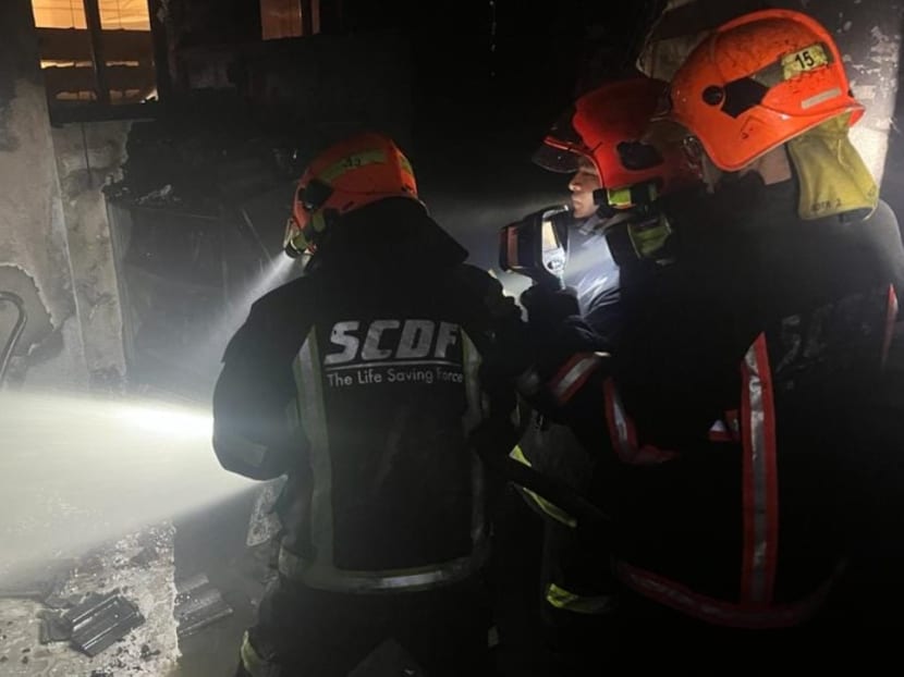Firefighters conducting damping down operations inside one of the affected units along East Coast Road on Jan 10, 2022.