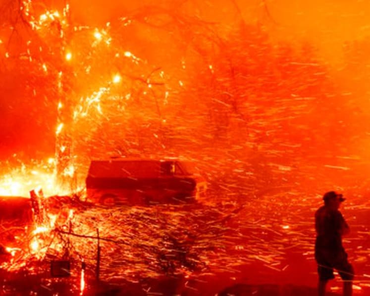 Wind fans wildfire in California canyons, residents flee