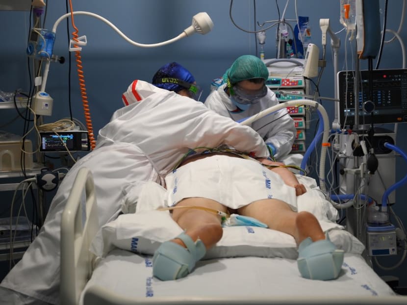 Healthcare workers attend to a patient at the Covid-19 Intensive Care Unit (ICU) of the Hospital Del Mar in Barcelona on Jan 20, 2021.