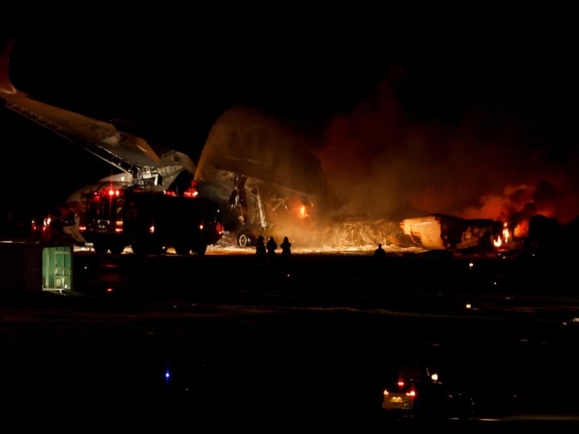 Firefighters work on a burning Japan Airlines' A350 airplane at Haneda International Airport in Tokyo, Japan.