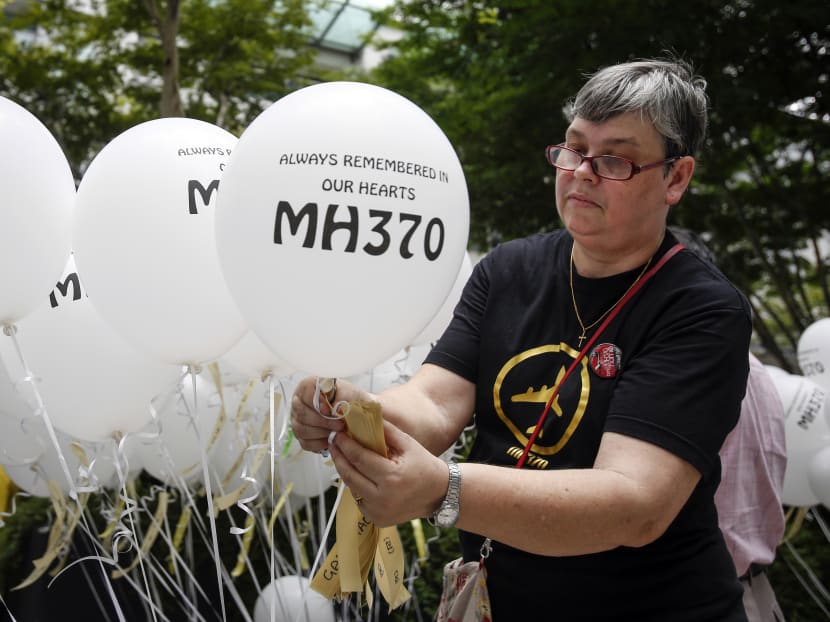 Ms Jacquita Gomes, wife of Patrick Gomes, the in-flight supervisor on the ill fated MH370, prepares balloons with names of those on board during a remembrance event in Kuala Lumpur, Malaysia, Sunday, March 6, 2016. PHOTO: AP