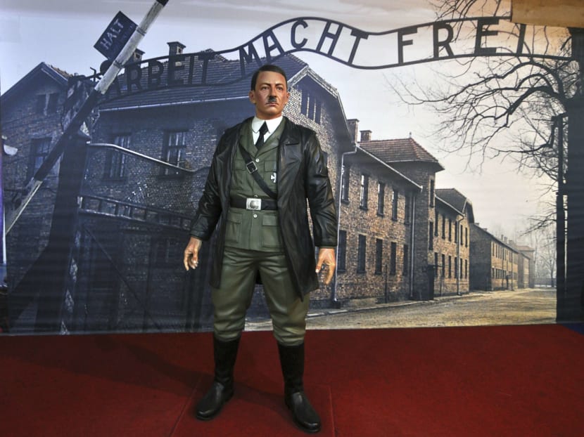 In this Wednesday, Nov 8, 2017, photo, a wax figure of Adolf Hitler is displayed against the backdrop of an image of Auschwitz-Birkenau complex of concentration camps, at the De Mata Museum in Yogyakarta, Indonesia. Rights groups have expressed outrage over the display, calling it "sickening" and that it "mocks the victims who went in and never came out". Photo: AP