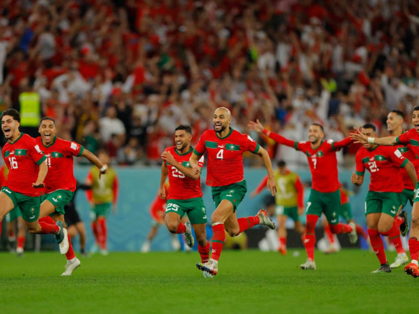 Morocco players celebrating after they won on a penalty shoot-out against Spain at the Qatar 2022 World Cup round-of-16 football match at the Education City Stadium in Al-Rayyan, west of Doha on Dec 6, 2022.