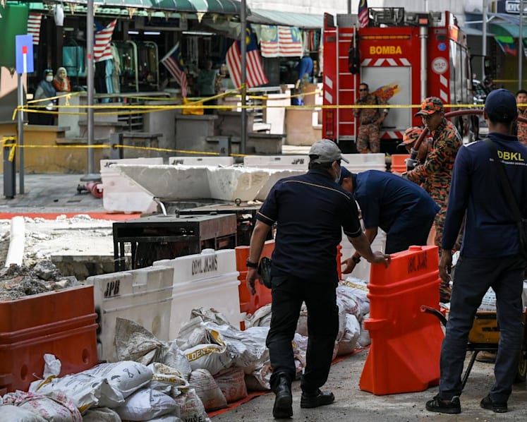 Malaysia searching manholes, sewage plant again for sinkhole victim as mayor declares Kuala Lumpur 'safe'