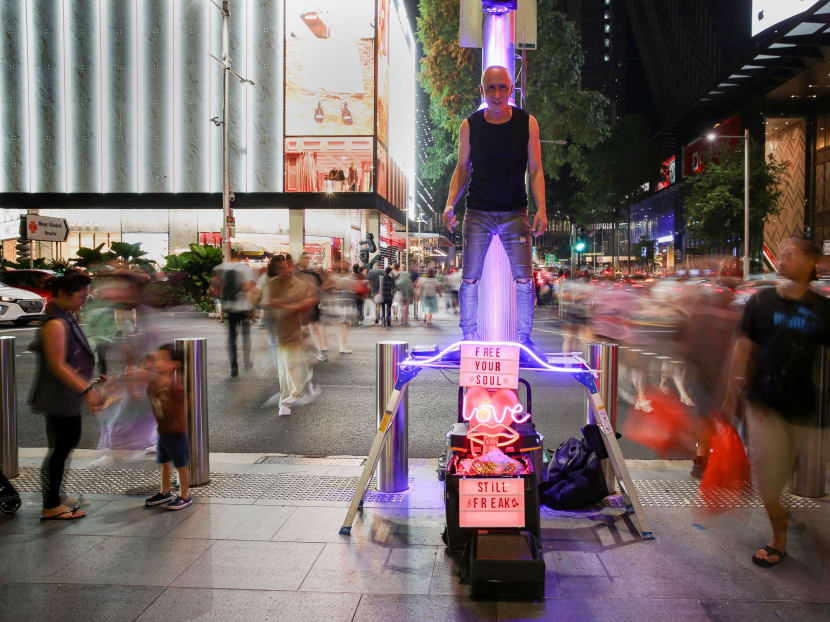 Veteran busker Roy Payamal, seen posing as a human statue along Orchard Road.