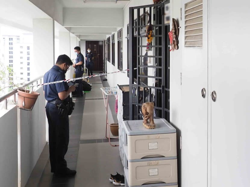 Police officers cordoning off a section of the common corridor outside a flat on Rivervale Drive, where a 67-year-old man was found with multiple wounds and later declared dead on Nov 4, 2022.