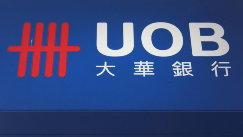 Woman jailed after kicking UOB employee in groin, tearing his shirt when she couldn’t get S$67,000