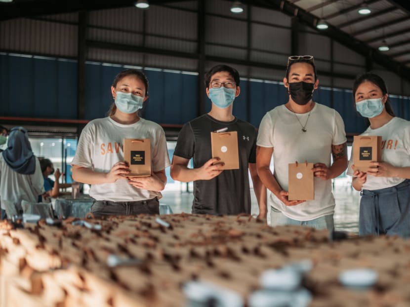The Savour! team pictured with staff members from the Crisis Relief Alliance at JTC Tuas Chinese New Year Festival held at Tuas South Recreation Centre. They distributed 400 cookies to migrant workers there.