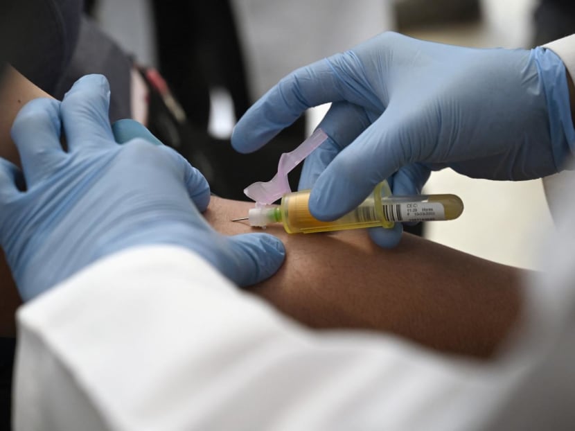 A technician extracts blood from a patient for an HIV test. A technician extracts blood from a patient for an HIV test.
