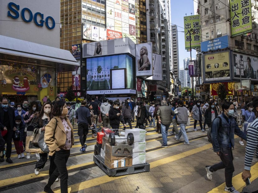 People walk through a shopping district in Hong Kong on December 22, 2022. People walk through a shopping district in Hong Kong on December 22, 2022.