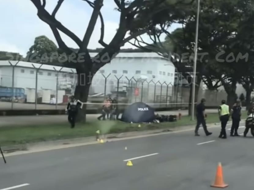 A screenshot from a video circulating on social media showing a toppled motorcycle on a grass patch beside a road, with a blue police tent next to it. A screenshot from a video circulating on social media showing a toppled motorcycle on a grass patch beside a road, with a blue police tent next to it.