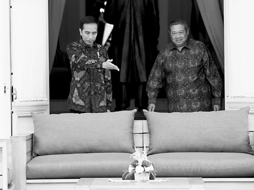 Indonesian President Joko Widodo (left) with former president Susilo Bambang Yudhoyono at the presidential palace in Jakarta, before their meeting earlier this month. Mr Yudhoyono was seen as tough because of his military background, while Mr Jokowi has no military ties. Photo: Reuters